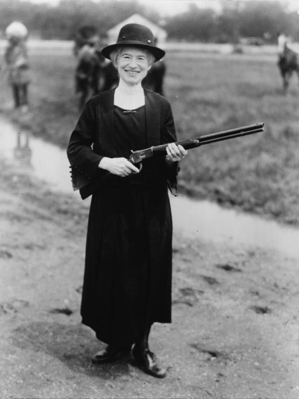 Annie Oakley posing during a shooting training.  